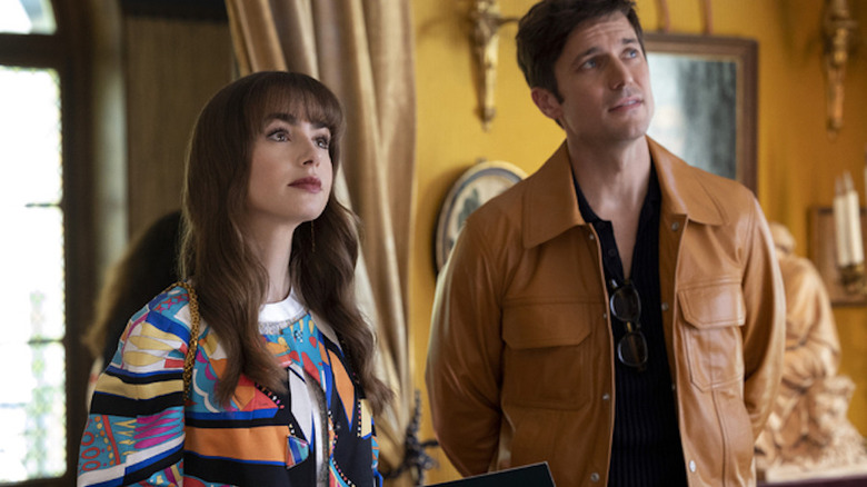 Lucas Bravo and Lily Collins looking up in Emily in Paris 