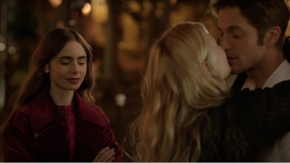 Emily (Lily Collins) watches her friend and love interest kiss during a scene included in Netflix's Emily in Paris trailer.