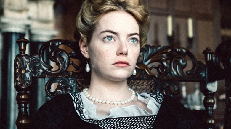 Stone sitting in ornate wooden chair with hair up