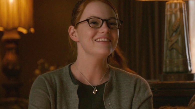 Stone smiling with glasses and ponytail 