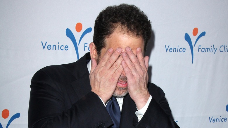 Brett Ratner covers eyes at event