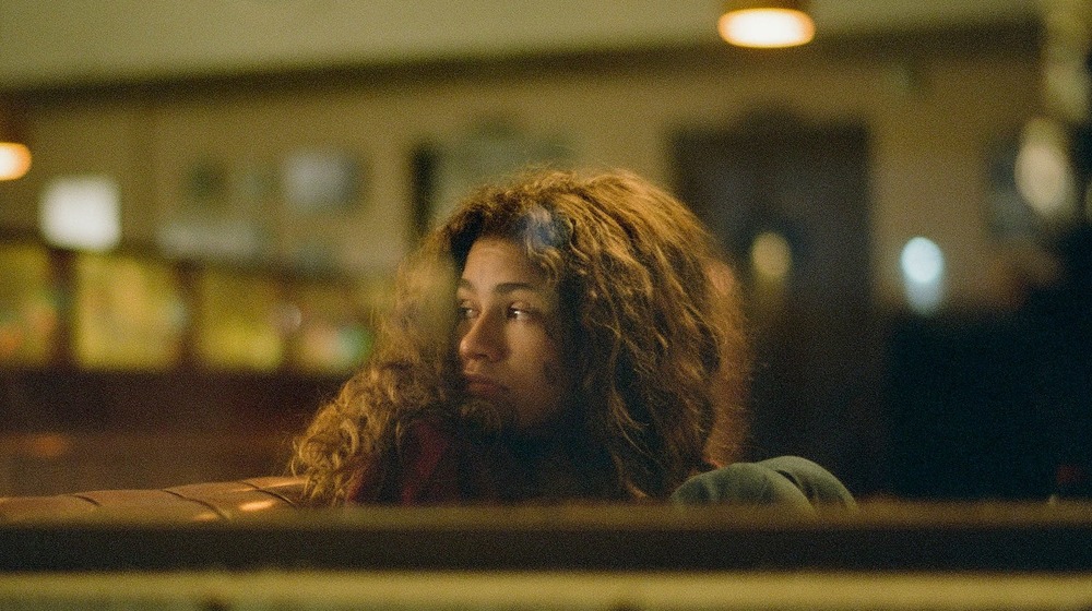 Rue waits in a diner