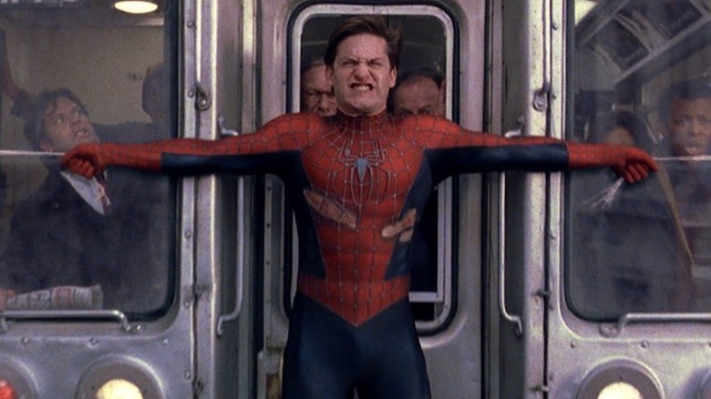 Spider-Man holding a train