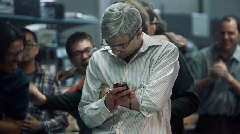 Mike Lazaridis holds a BlackBerry phone 