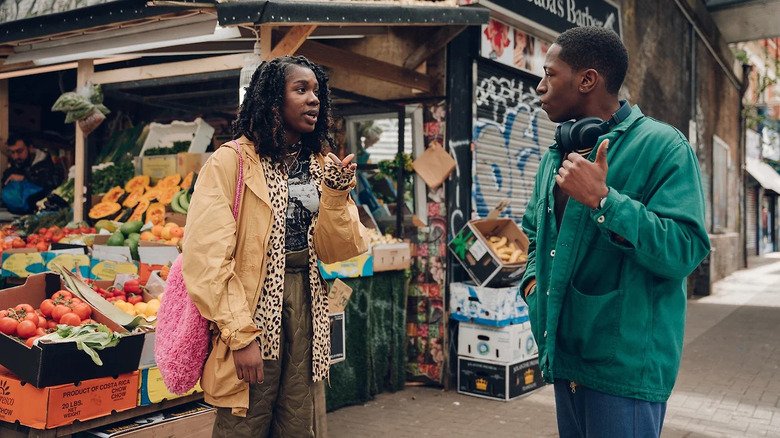 Yas and Dom talk outside a grocery store