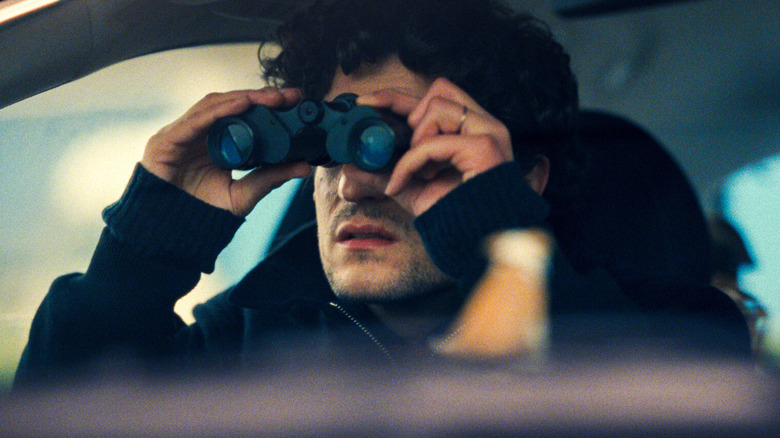 Abel with binoculars in car