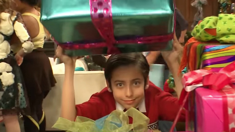 Aidan Gallagher holding Christmas present