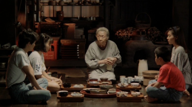 Family kneels at dinner