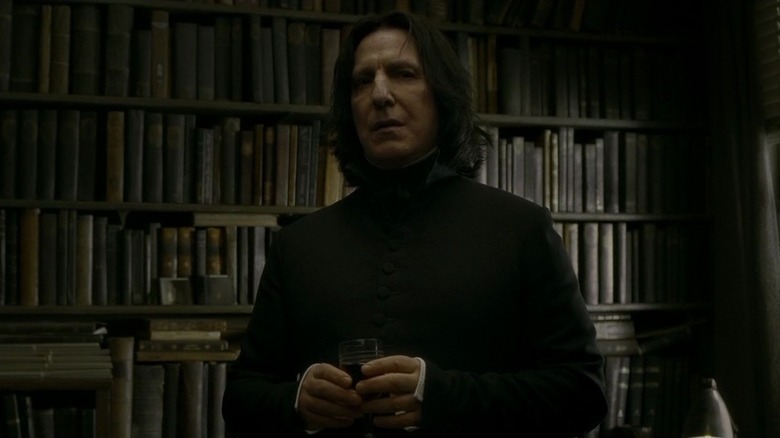 Severus Snape in front of books