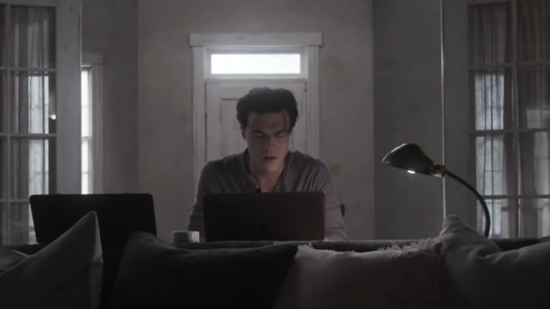 Finn Wittrock writes on his computer