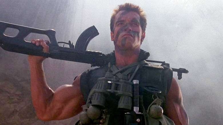 Arnold holds a gun over his shoulder