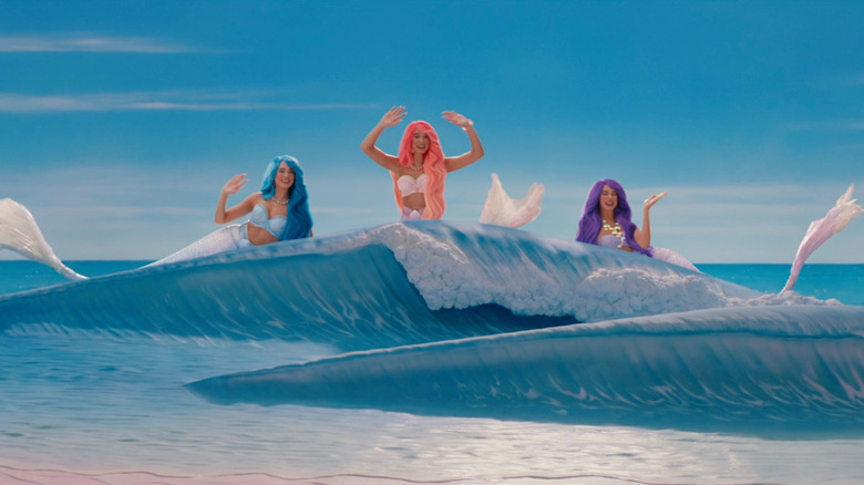 Mermaid Barbies waving