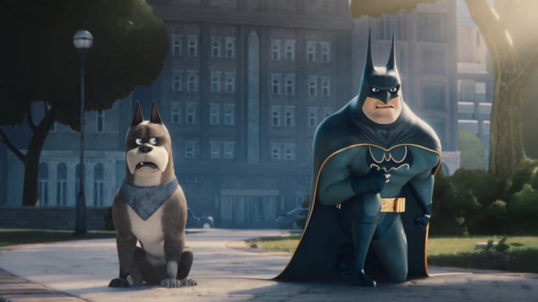 Batman kneels beside his dog Ace in DC's League of Super-Pets