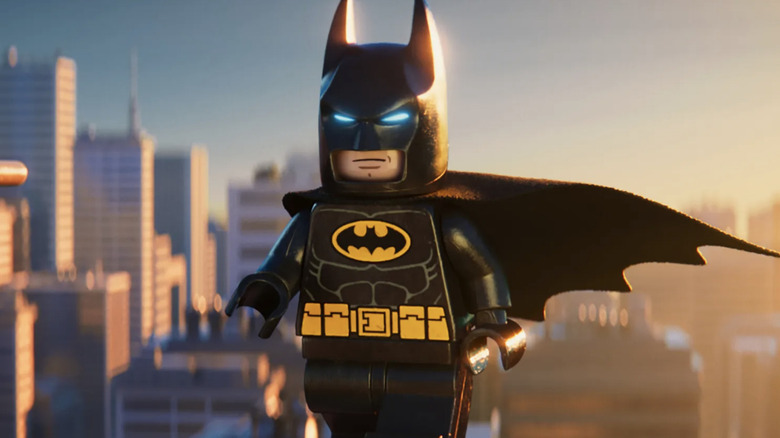 Lego Batman stands above a Lego Gotham in The Lego Batman Movie