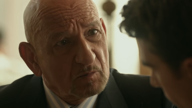 Ben Kingsley talking in a suit