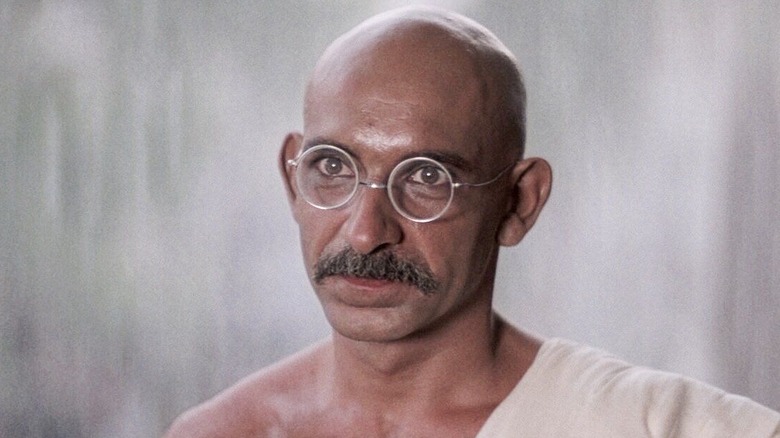 Ben Kingsley bald with glasses and mustache