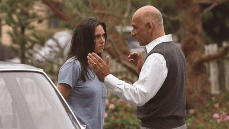 Jennifer Connelly and Ben Kingsley talking by a car