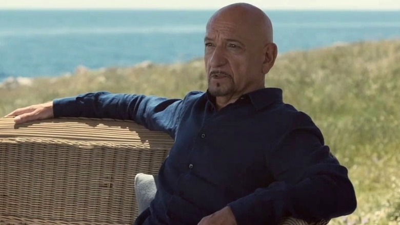 Ben Kingsley sitting on wicker furniture