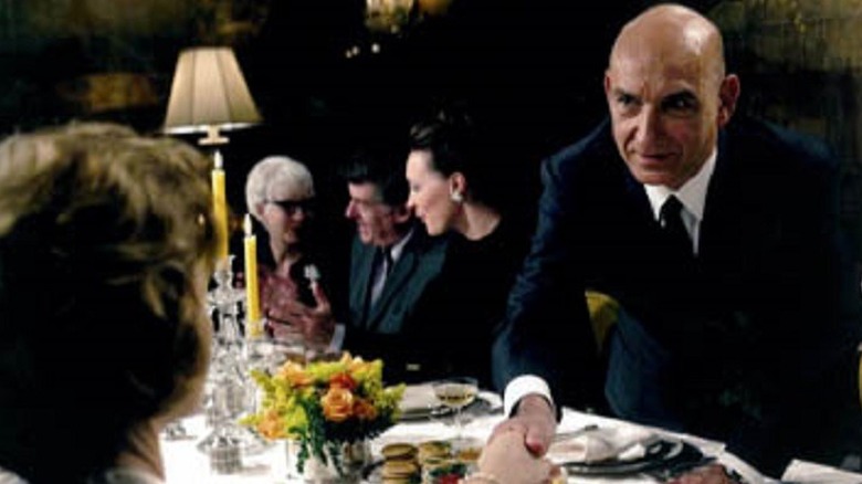 Ben Kingsley greets woman at table