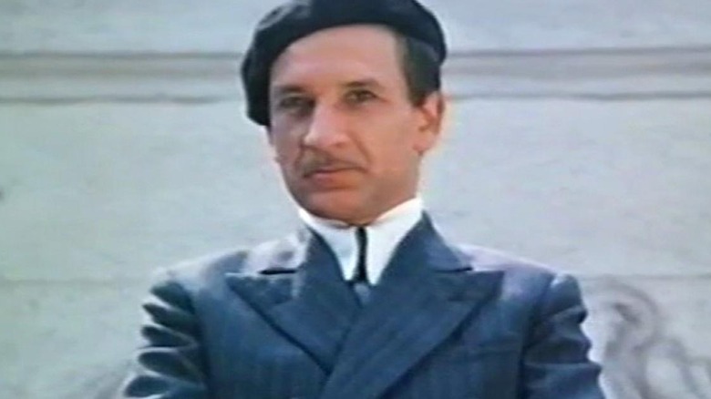 Ben Kingsley in blue suit and hat