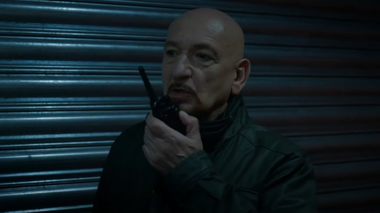 Ben Kingsley holding walkie talkie