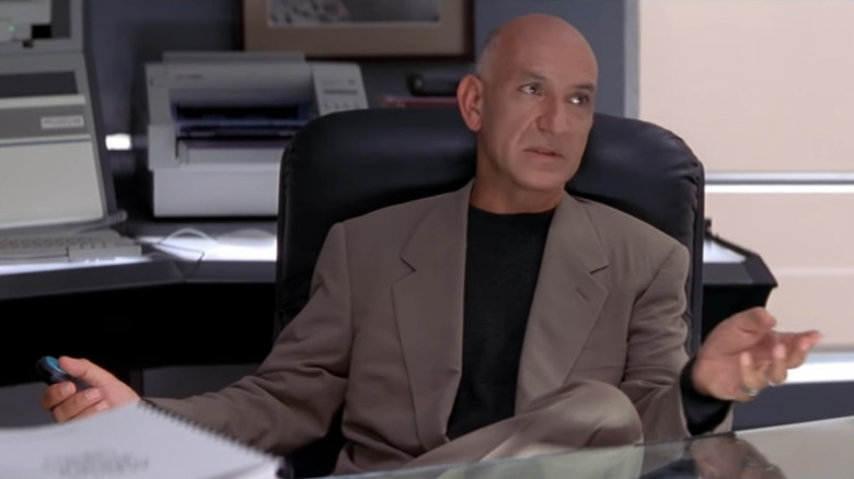 Ben Kingsley speaking in an office