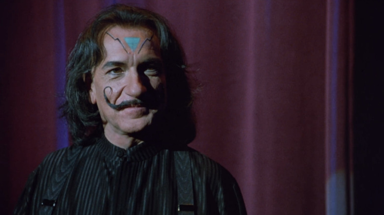 Ben Kingsley with a twirled mustache on stage