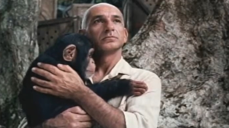 Ben Kingsley in the jungle holding monkey