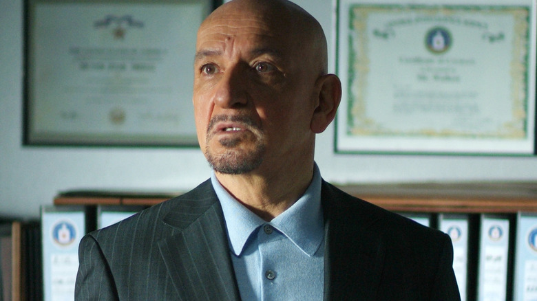 Ben Kingsley in front of plaques