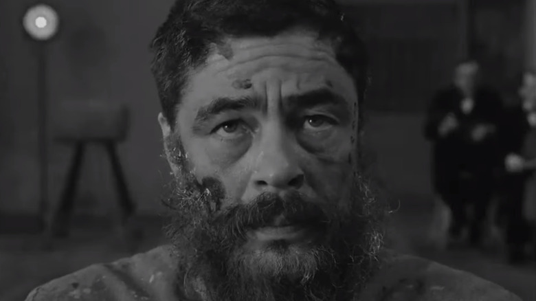 Benicio Del Toro covered in paint