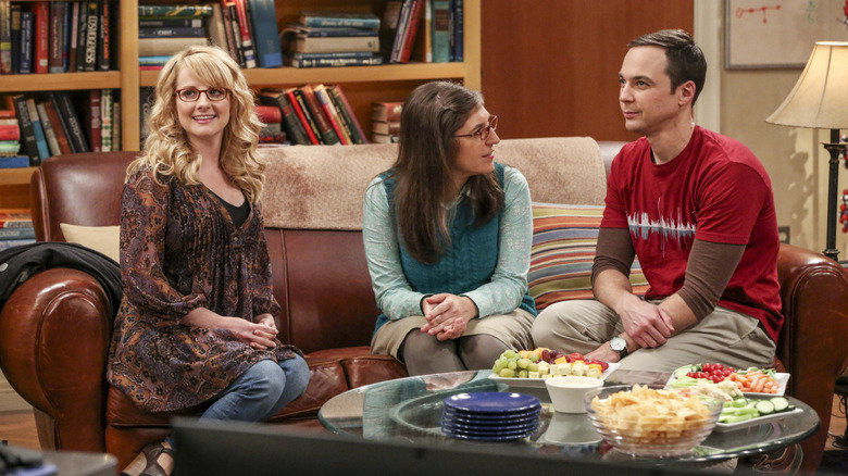 Bernadette, Amy, and Sheldon sitting on the couch