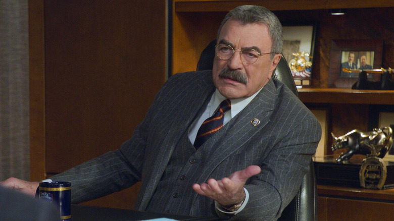 Frank Reagan sits at his desk