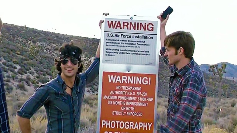 Two teens and an Area 51 sign