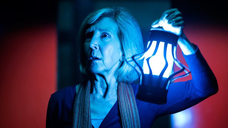 Lin Shaye holding an ominous lantern