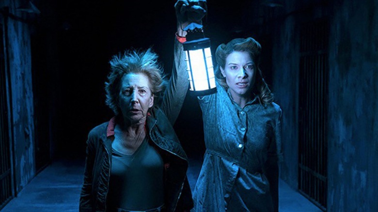 Lin Shaye with lantern in the dark