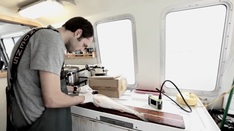 Man cutting open fish