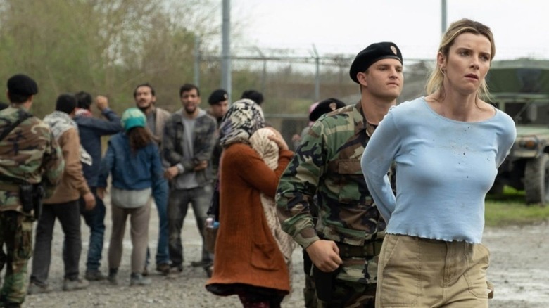 Betty Gilpin handcuffed by soldiers