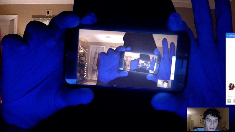 Figure holding phone recording the screen