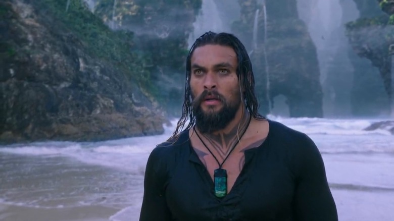 Aquaman walking along beach