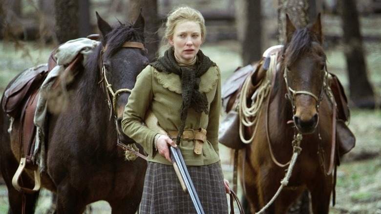 Maggie Gilkeson holding rifle