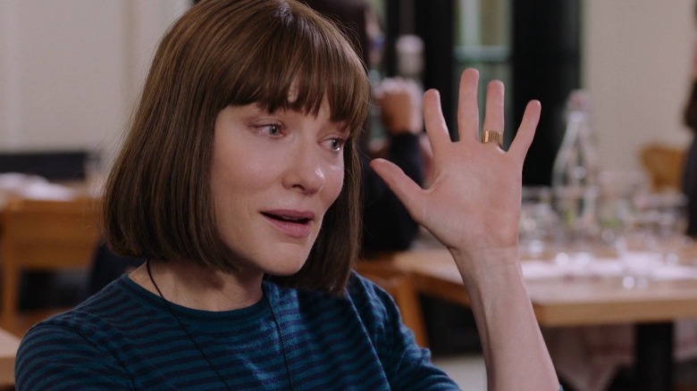 Bernadette waving hand in exasperation