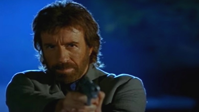 Chuck Norris holding a gun