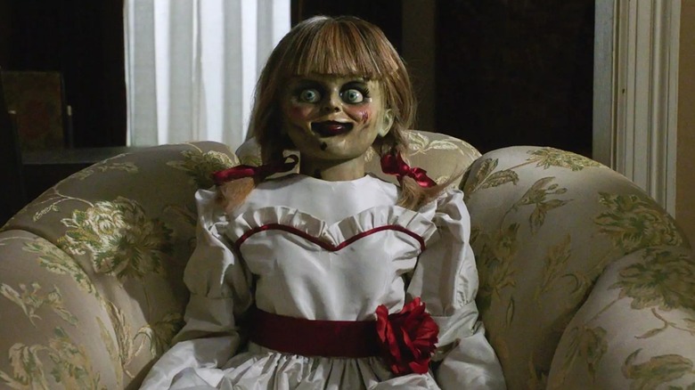 Annabelle doll sitting in chair