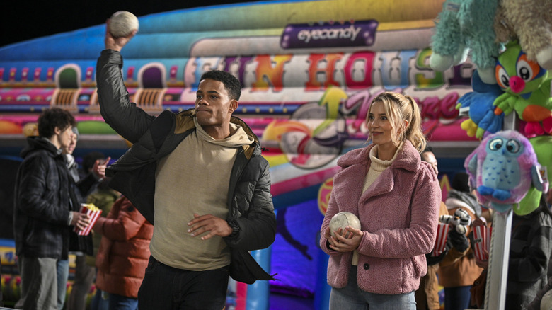 Cara and Jake playing games at a carnival