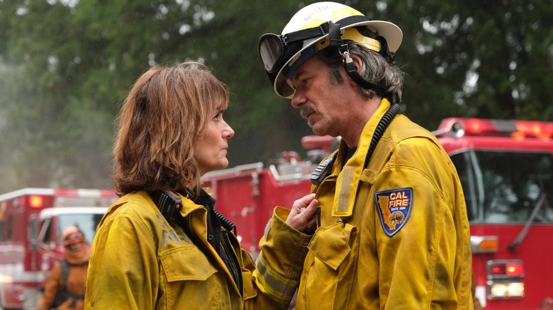 Sharon and Vince Leone comforting each other in firefighter uniform