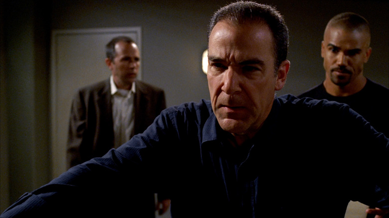 Morgan standing behind Gideon inside Criminal Minds