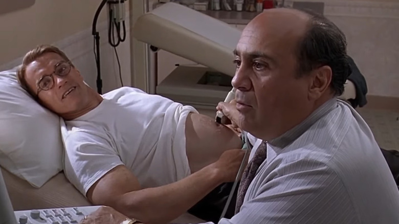 Danny DeVito runs a sonogram on a pregnant Arnold Schwarzenegger