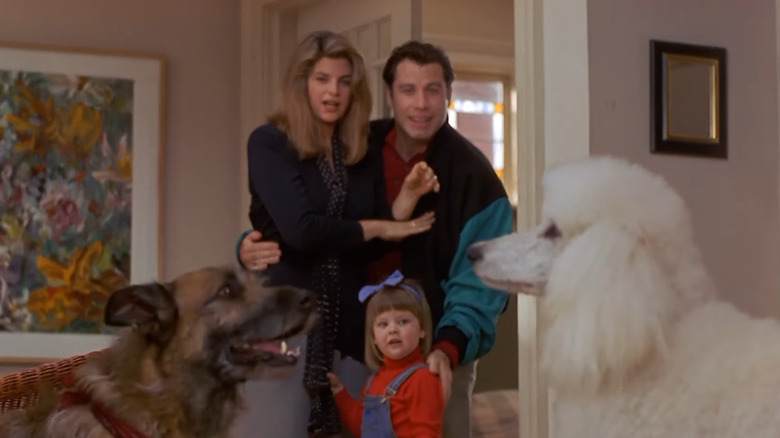 John Travolta and Kirstie Alley look at a pair of dogs
