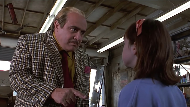 Danny DeVito looks down on Mara Wilson