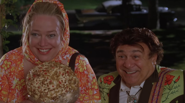 Kathy Bates and Danny DeVito hold a large cheese ball